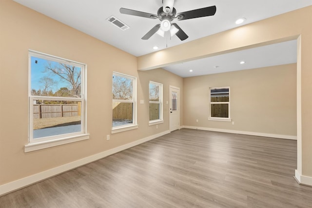 spare room with recessed lighting, visible vents, ceiling fan, wood finished floors, and baseboards