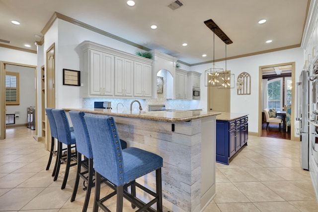 kitchen featuring light stone counters, light tile patterned flooring, blue cabinets, a breakfast bar, and visible vents