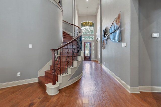 17715 Lakeside Haven Dr, Cypress, TX 77433 - entrance foyer with wood finished floors, a chandelier, baseboards, stairs, and a high ceiling