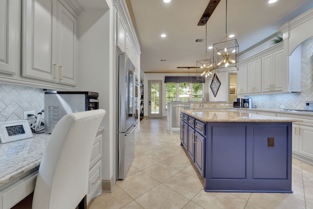 kitchen with light tile patterned floors, high quality fridge, crown molding, blue cabinetry, and white cabinetry