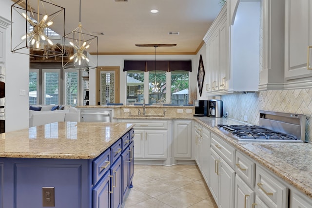 17715 Lakeside Haven Dr, Cypress, TX 77433 - kitchen featuring blue cabinetry, a chandelier, appliances with stainless steel finishes, white cabinetry, and a sink