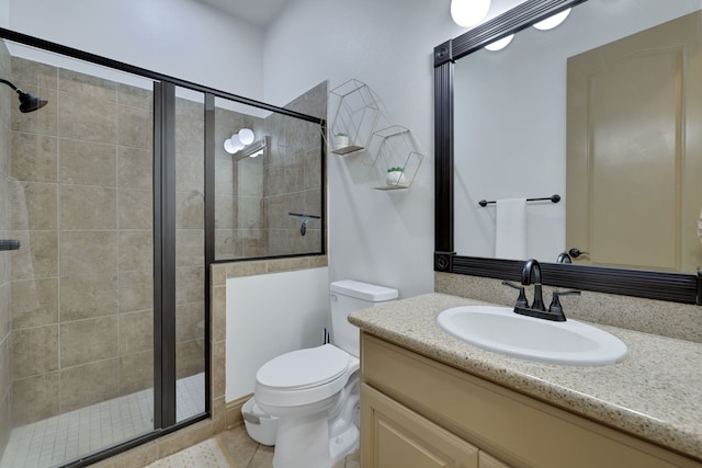 full bathroom with a stall shower, tile patterned flooring, vanity, and toilet