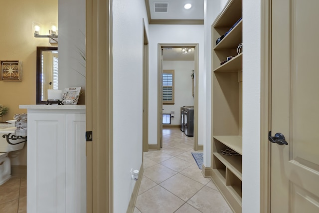 interior space with ornamental molding, tile patterned flooring, visible vents, and baseboards