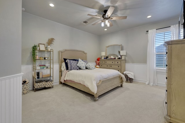 bedroom featuring a wainscoted wall, visible vents, carpet flooring, and recessed lighting