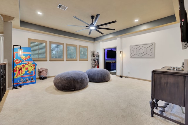 playroom featuring visible vents, baseboards, a ceiling fan, a tray ceiling, and carpet