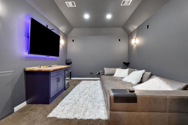 carpeted cinema room featuring beverage cooler, visible vents, and baseboards