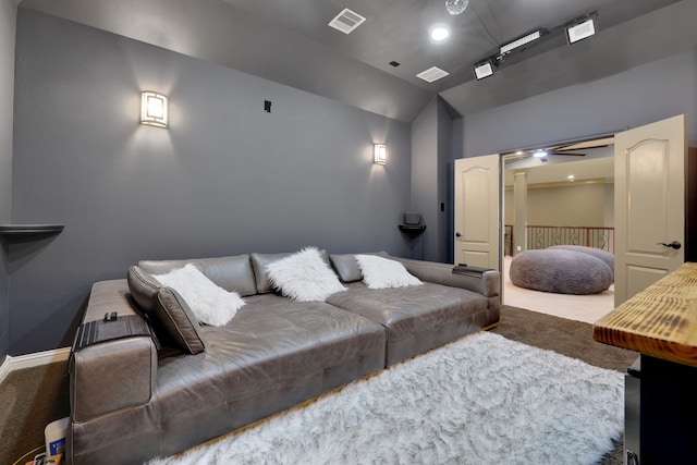 cinema featuring carpet, visible vents, vaulted ceiling, and baseboards