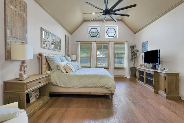 bedroom with high vaulted ceiling, ceiling fan, and wood finished floors