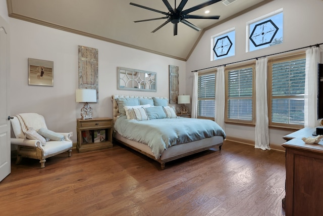 bedroom featuring baseboards, a ceiling fan, ornamental molding, wood finished floors, and high vaulted ceiling