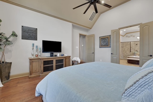 bedroom with visible vents, ornamental molding, ensuite bath, wood finished floors, and baseboards