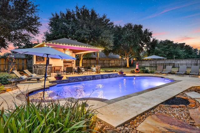 17715 Lakeside Haven Dr, Cypress, TX 77433 - pool at dusk featuring a patio and a fenced backyard