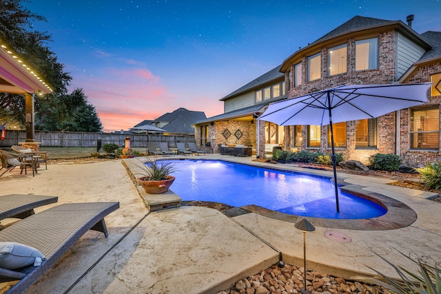 17715 Lakeside Haven Dr, Cypress, TX 77433 - pool at dusk featuring a patio area and a fenced backyard