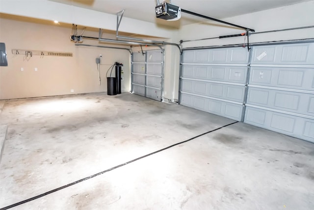 garage with a garage door opener and electric panel