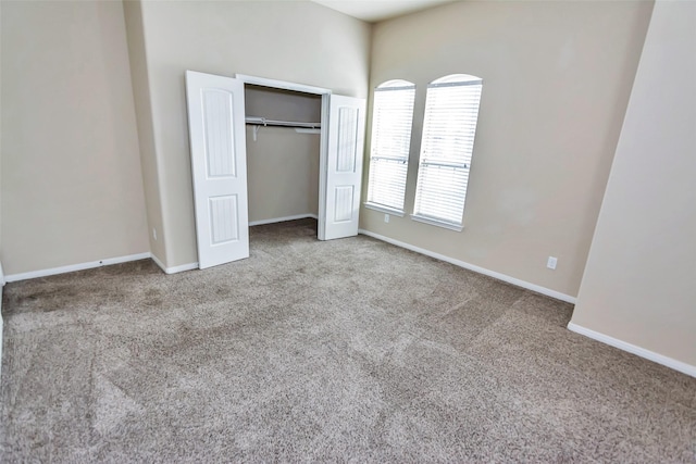 unfurnished bedroom with a closet and carpet