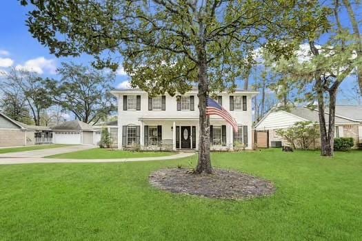 view of front of home with a garage and a front lawn