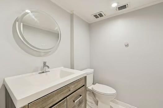 bathroom featuring vanity and toilet