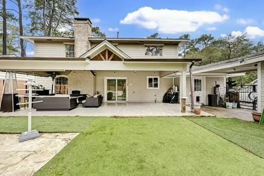 back of house featuring an outdoor living space, a patio, and a lawn