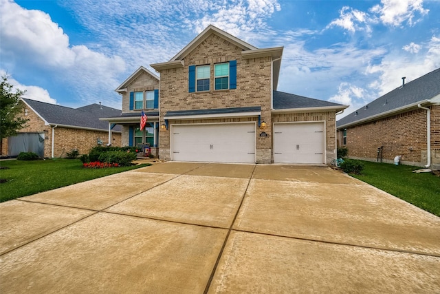 view of front of property with a garage and a front lawn