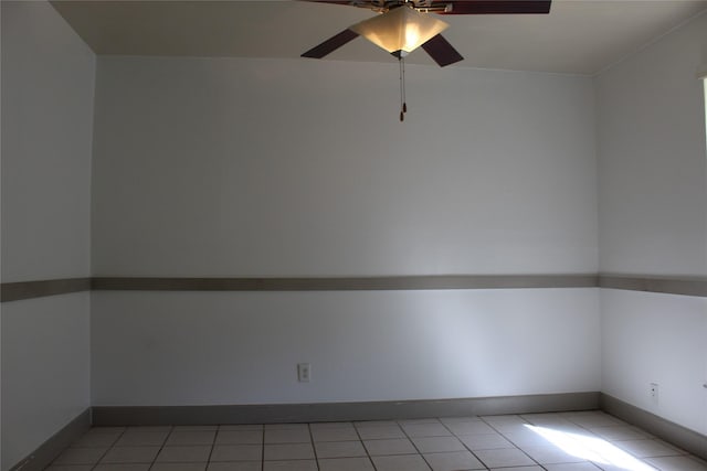 tiled empty room featuring ceiling fan