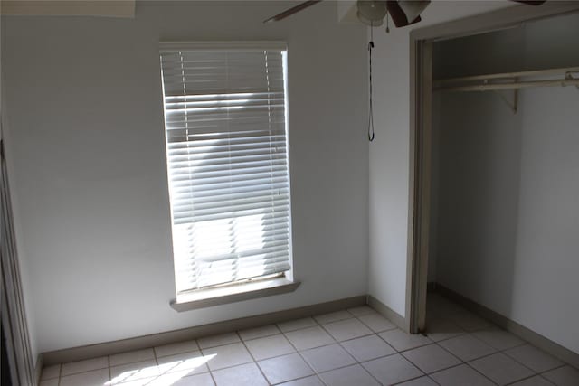 unfurnished bedroom with a closet and light tile patterned floors