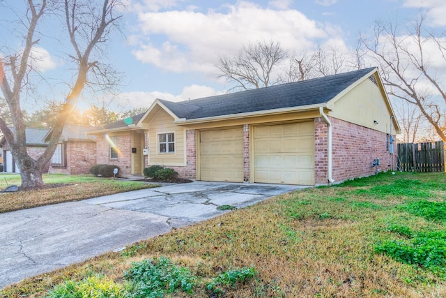 ranch-style house featuring a garage and a front yard