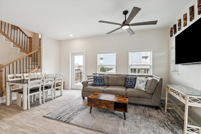 living room with ceiling fan and light wood-type flooring