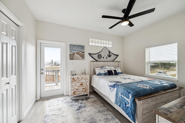 bedroom with hardwood / wood-style flooring, ceiling fan, and access to exterior