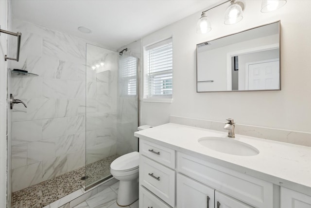 bathroom featuring tiled shower, vanity, and toilet