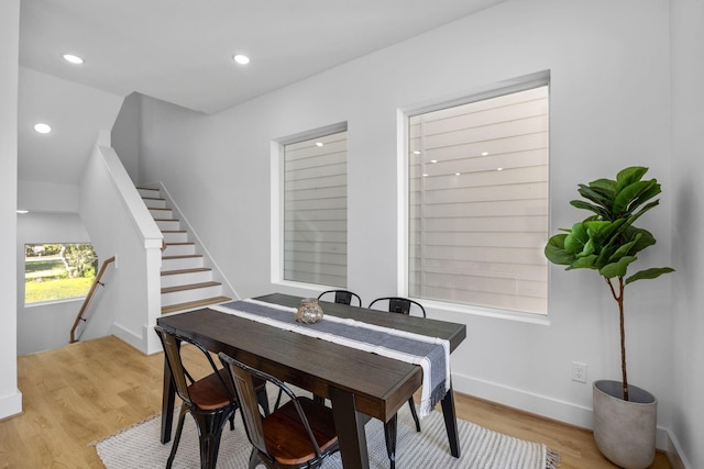 dining room with recessed lighting, light wood-style floors, and baseboards