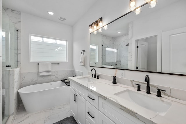 bathroom with a sink, a marble finish shower, marble finish floor, and visible vents