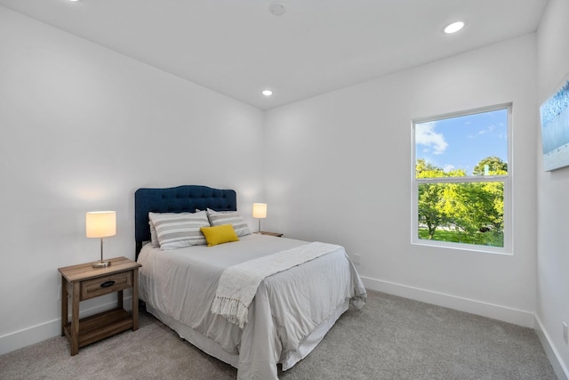 carpeted bedroom featuring recessed lighting and baseboards