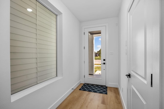 entryway featuring baseboards and light wood finished floors