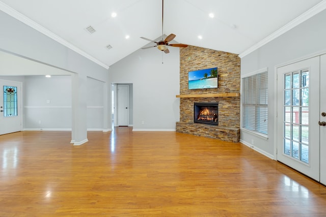 unfurnished living room featuring light hardwood / wood-style flooring, ceiling fan, high vaulted ceiling, a fireplace, and ornamental molding