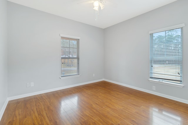 empty room featuring ceiling fan and hardwood / wood-style floors