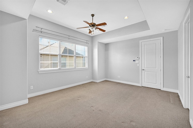 carpeted spare room featuring ceiling fan