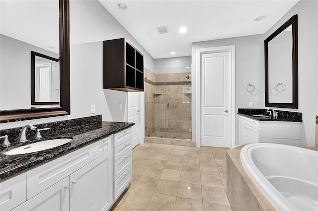 bathroom featuring vanity, shower with separate bathtub, and tile patterned flooring