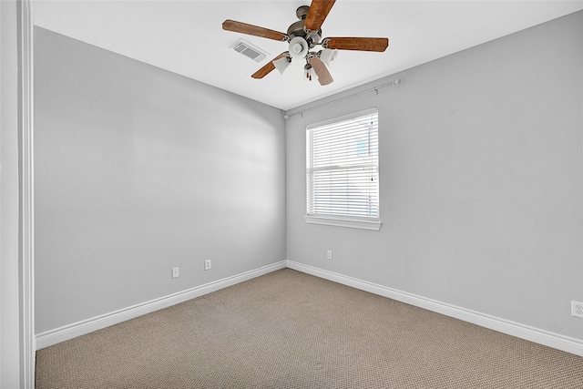 empty room with ceiling fan and light carpet