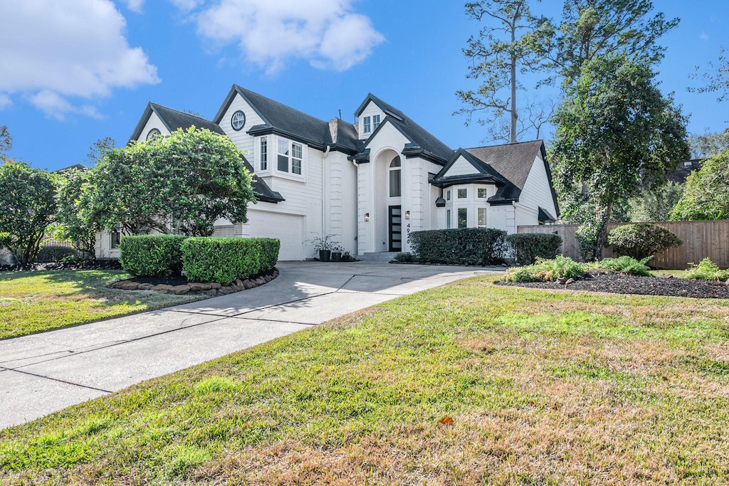 view of front of home with a garage and a front lawn