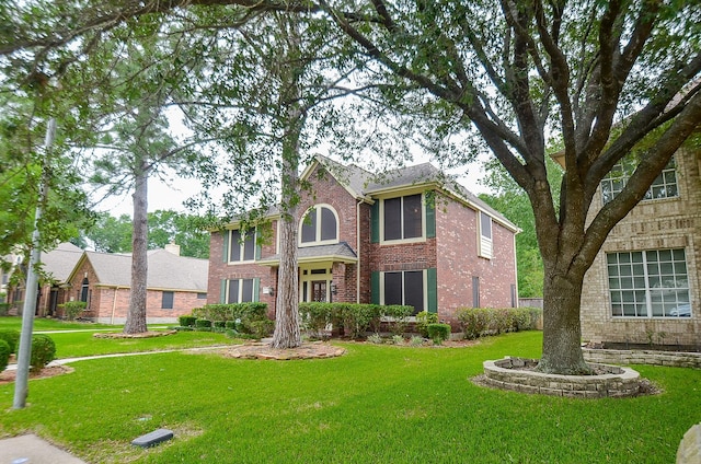 colonial-style house with a front yard