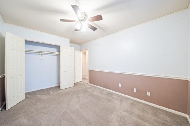 unfurnished bedroom featuring light colored carpet, a closet, and ceiling fan