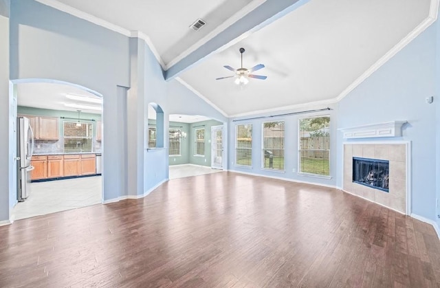 unfurnished living room with crown molding, a fireplace, and light wood-type flooring