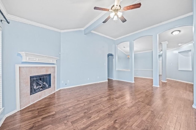 unfurnished living room featuring hardwood / wood-style flooring, ornamental molding, a tile fireplace, and ceiling fan