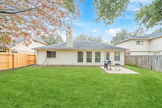 back of property with a lawn and a patio