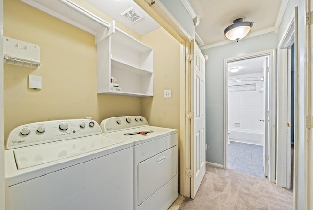 laundry room featuring ornamental molding, separate washer and dryer, and light colored carpet