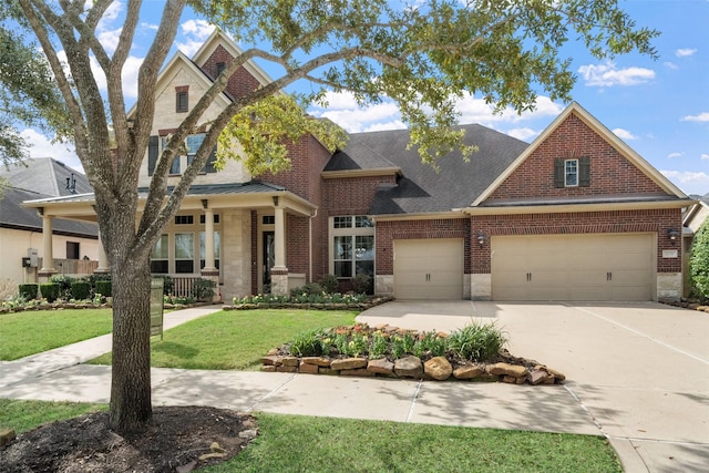 view of front of property with a garage, driveway, stone siding, a front lawn, and brick siding