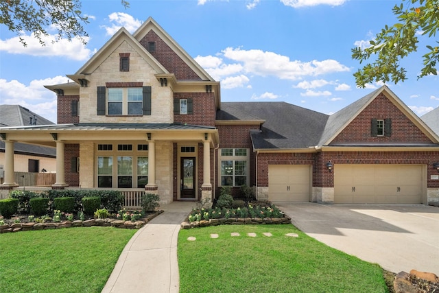 view of front of property featuring stone siding, an attached garage, covered porch, a front lawn, and brick siding