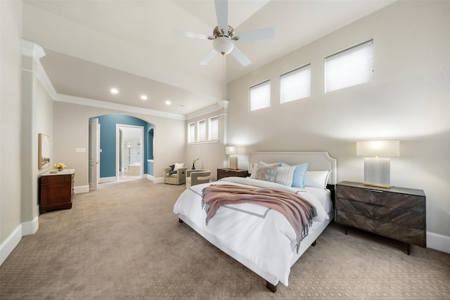 bedroom featuring crown molding, connected bathroom, light colored carpet, and ceiling fan