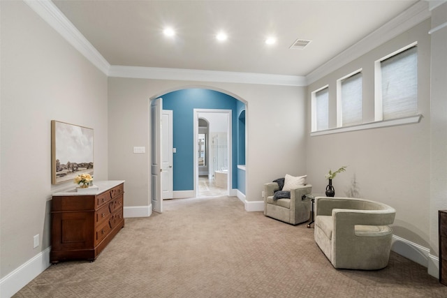 sitting room featuring light carpet and crown molding