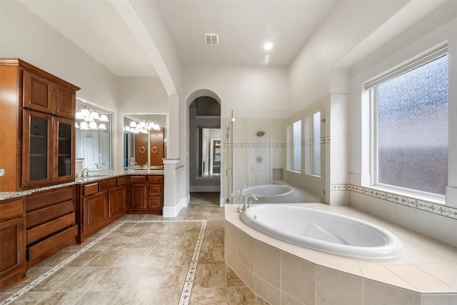 bathroom featuring a garden tub, vanity, visible vents, baseboards, and a stall shower