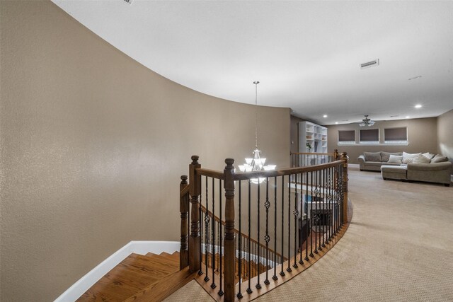 staircase featuring carpet and an inviting chandelier